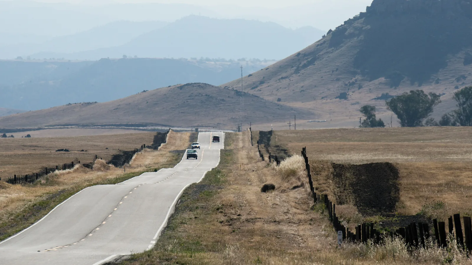 Two lane country road running through dry foothill ranch land
