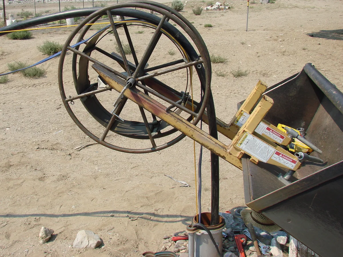 Drop pipe being pulled from a well casing onto a reel during a pump pull